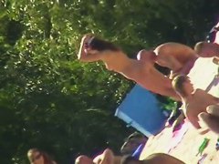 Hot brunette bares it all to the nudist beach voyeur