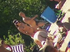 Hot brunette bares it all to the nudist beach voyeur