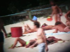Nudist beach with dressed gentlemen and topless ladies