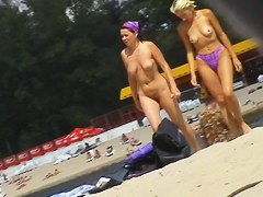 Guy resting on beach spies pretty beach nudist girl