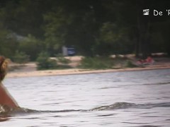 Sun warming up bodies of beach nudist girls and men