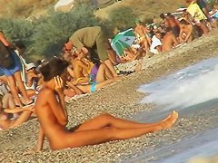 Sexy beach nudist girl spied talking on phone near water
