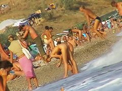 Sexy beach nudist girl spied talking on phone near water