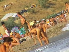 Sexy beach nudist girl spied talking on phone near water