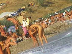 Sexy beach nudist girl spied talking on phone near water