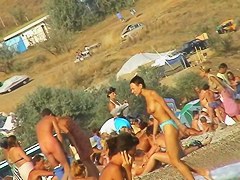 Sexy beach nudist girl spied talking on phone near water