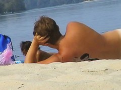 A horny nude beach couple fooling around while being filmed by a spy