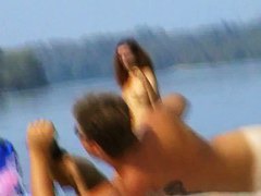 A horny nude beach couple fooling around while being filmed by a spy