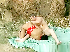 Tanned chick gets horny and mounts her chubby lover's dick while outdoors