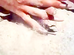 Long nails and sand on the beach