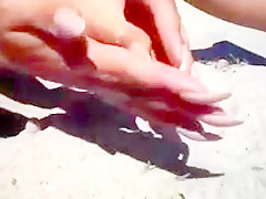 Long nails and sand on the beach