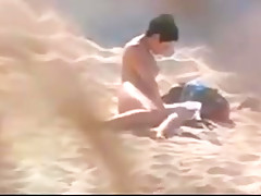 Nude beach - hot brunette plays for voyeur