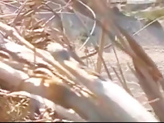 Nude beach - hot brunette plays for voyeur