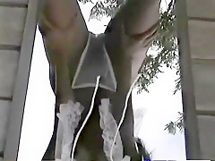 Naughty asian babe with a nice tan gropes her round ass outdoors