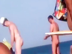 a couple masturbates on nudist beach