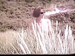 Cleo walking naked in the dunes