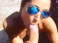 Sexy girlfriend blows on the beach