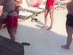 Public stripping game topless in Greece