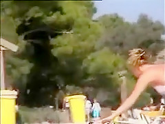 Deux copines topless simulent de baiser sur la plage