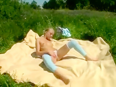Blonde Teen Chilling In The Grass