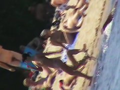 Cool babes with delicious tits taking sunbaths on a nude beach