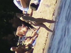 Cool babes with delicious tits taking sunbaths on a nude beach