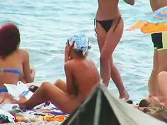 Buxom nude beach babes flaunt their jugs before a hidden camera