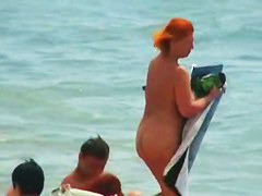 Buxom nude beach babes flaunt their jugs before a hidden camera