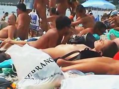 Buxom nude beach babes flaunt their jugs before a hidden camera