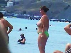Buxom nude beach babes flaunt their jugs before a hidden camera