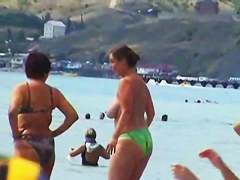 Buxom nude beach babes flaunt their jugs before a hidden camera