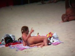 Brunette cutie with a perky butt filmed on a nudist beach