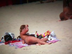 Brunette cutie with a perky butt filmed on a nudist beach