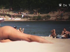 Beach nudist girl talks on phone and gets voyeured