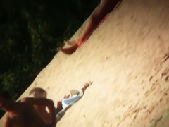 Two brunettes and one blonde on a nudist beach tanning and bending