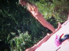 Two brunettes and one blonde on a nudist beach tanning and bending