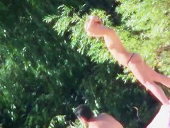 Two brunettes and one blonde on a nudist beach tanning and bending
