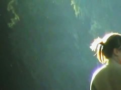 A tempting bimbo feeling giddy on a nude beach