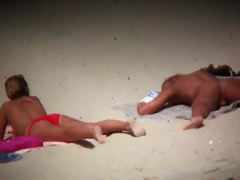 Big breasted woman meeting a hunk on the nude beach