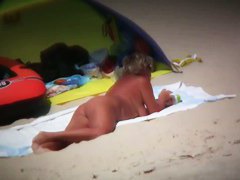 Big breasted woman meeting a hunk on the nude beach