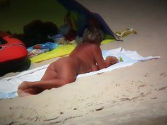 Big breasted woman meeting a hunk on the nude beach