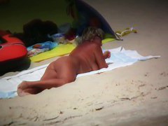 Big breasted woman meeting a hunk on the nude beach