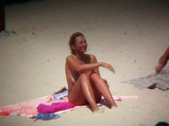 Big breasted woman meeting a hunk on the nude beach
