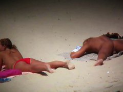 Big breasted woman meeting a hunk on the nude beach