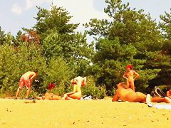 Naked people enloyong the sun on the beach