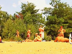 Naked people enloyong the sun on the beach