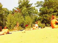 Naked people enloyong the sun on the beach
