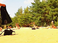 Naked people enloyong the sun on the beach