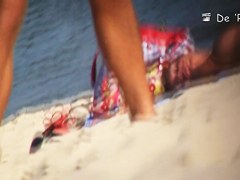 Beach voyeur man enjoys the view of topless female tits