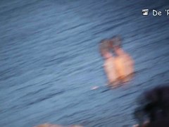 Beach voyeur man enjoys the view of topless female tits